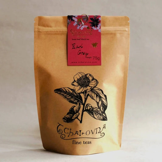Tchai-Ovna Earl Grey Tea in a brown paper bag on a cream background