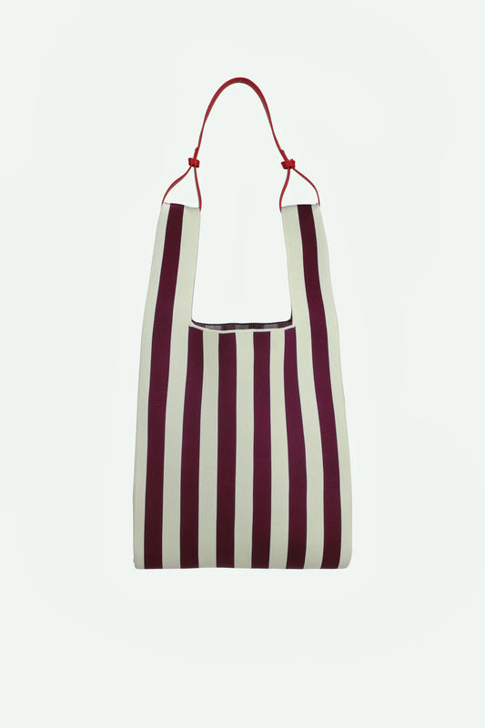 Striped bag with red handle on a white background
