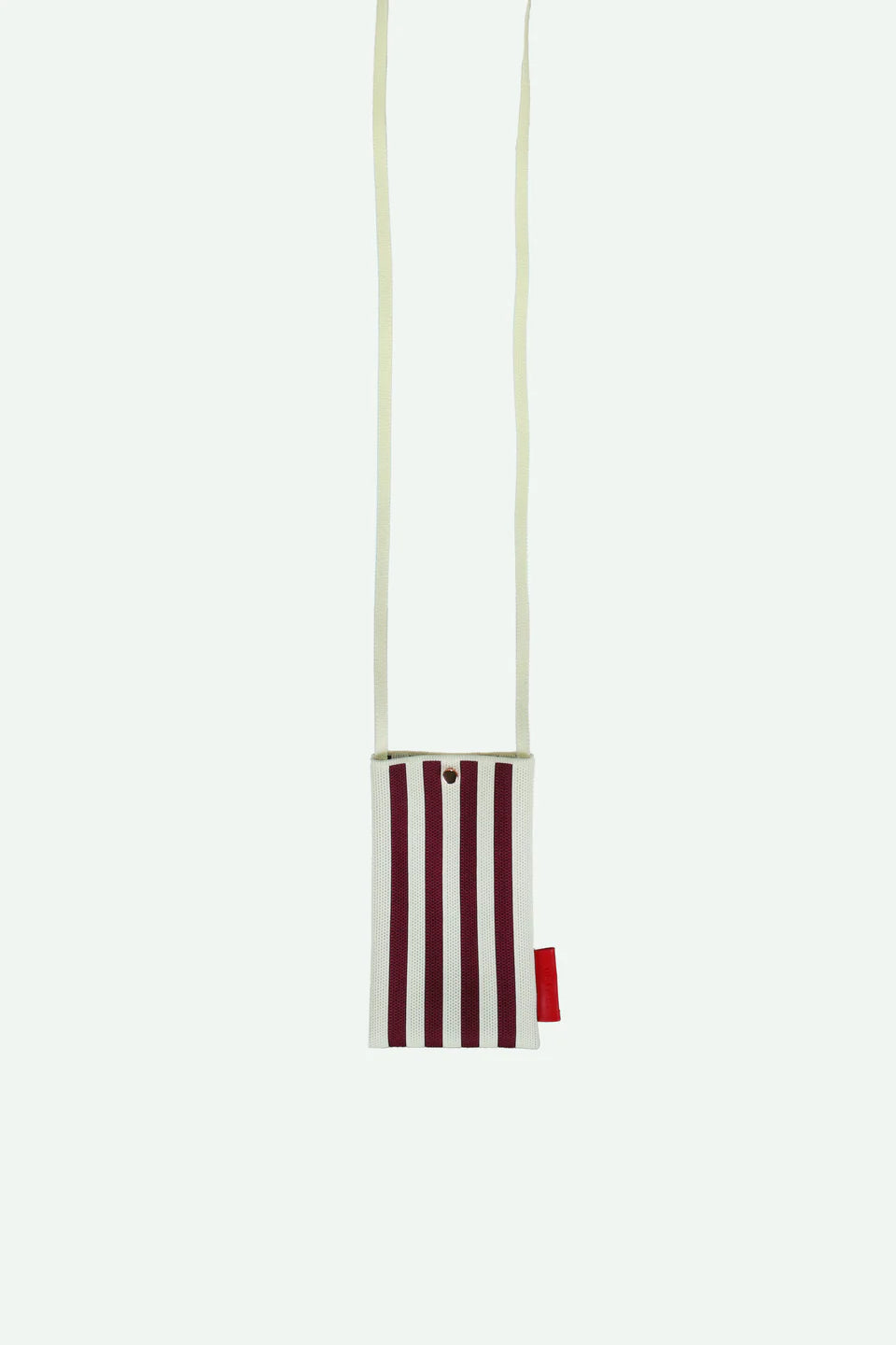 Striped pouch with a red tag on a white background