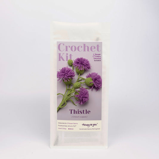 Crochet kit packaging with thistle design on a white background