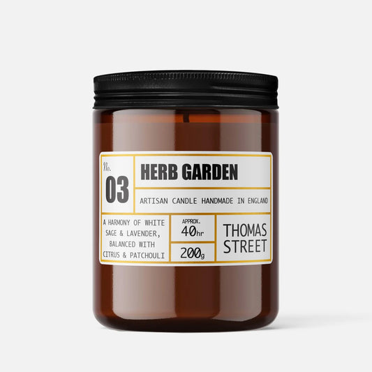 Candle labeled 'Herb Garden' by Thomas Street on a white background