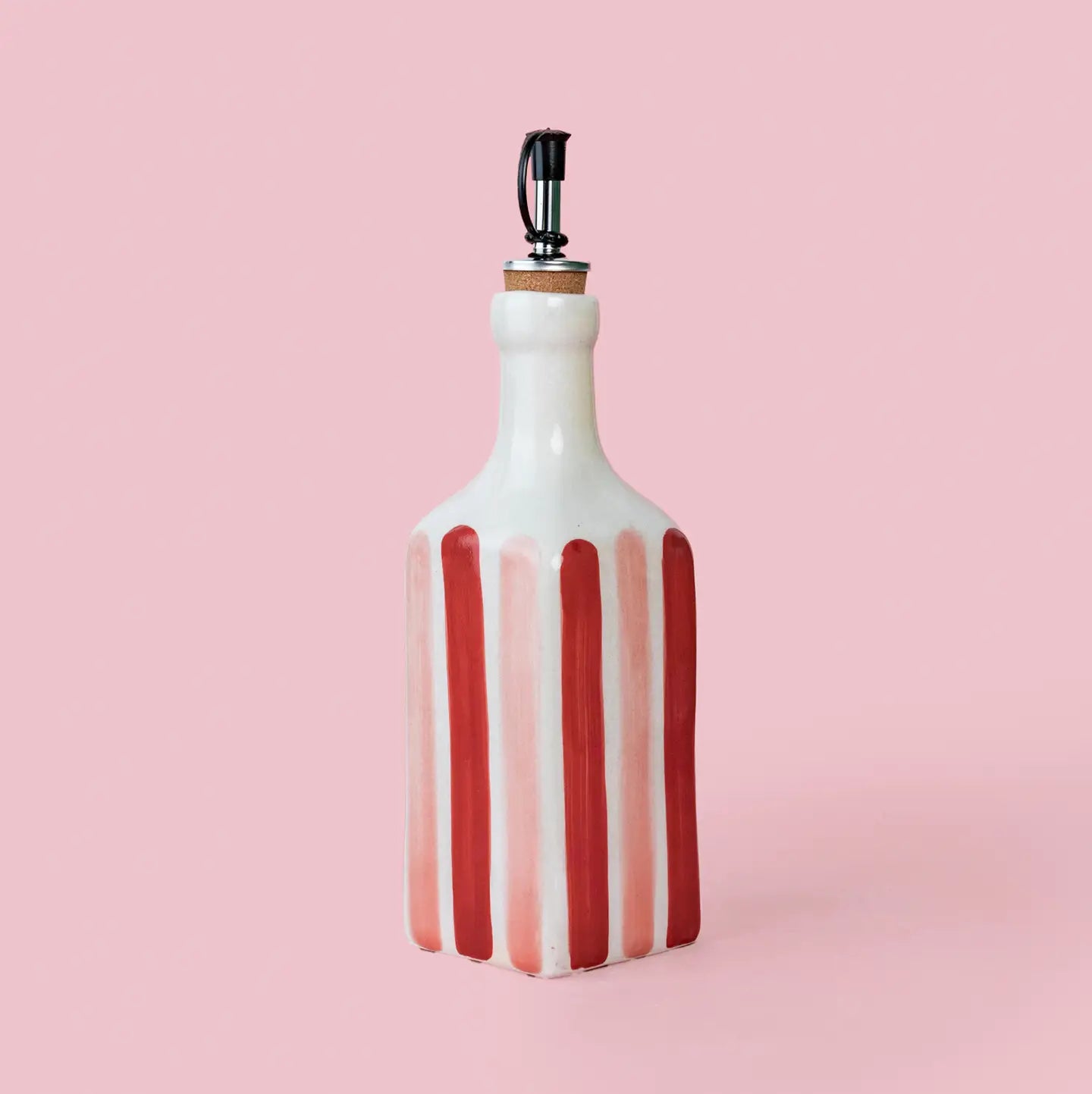 Tierra Cocida Ceramic Oil Dispenser in  Red/Pink Sweetheart stripes on a pink background 