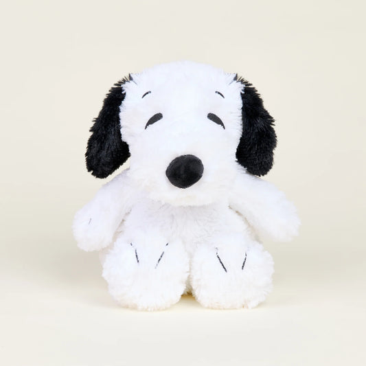 Plush toy resembling a black and white dog on a beige background