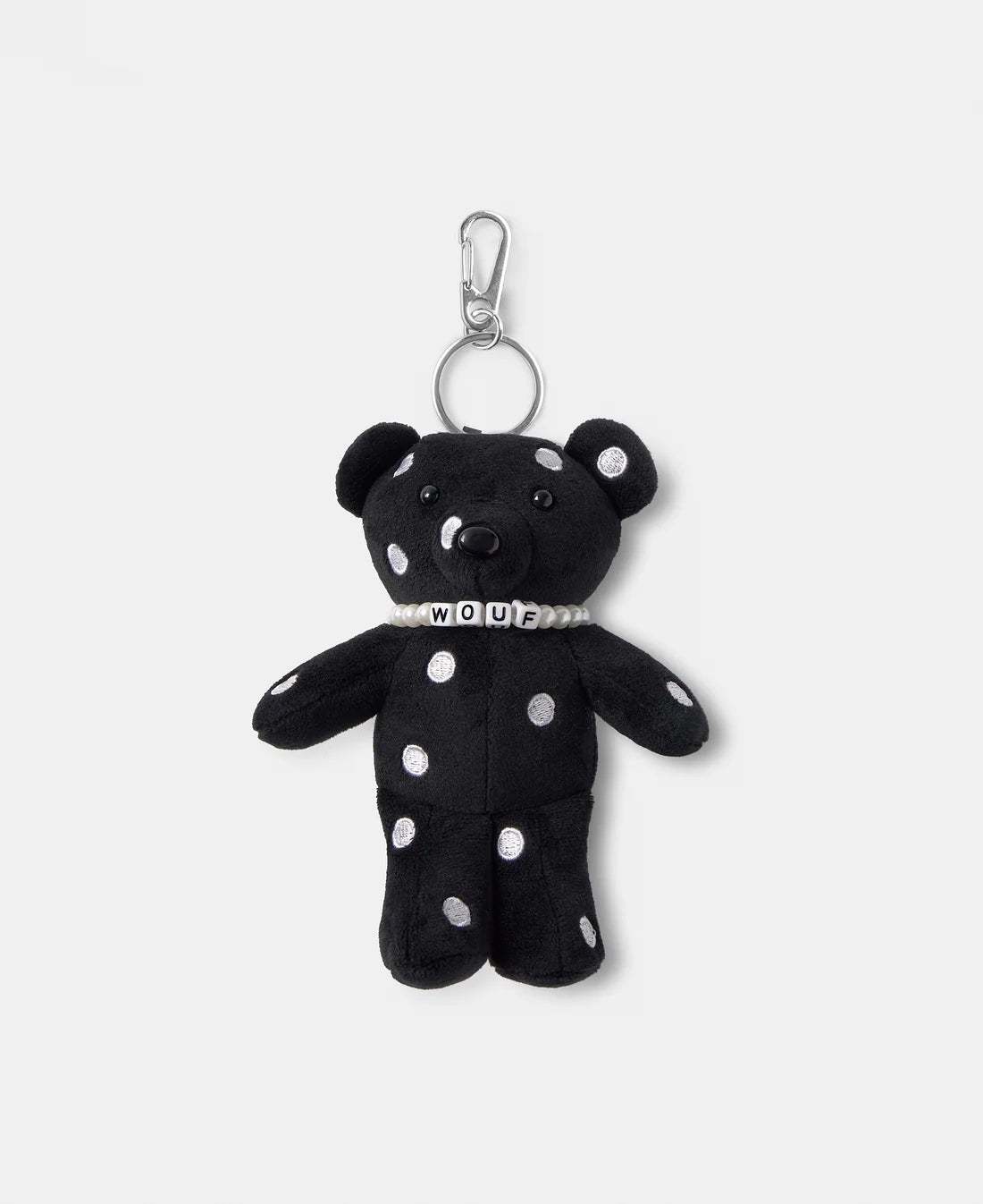 Black teddy bear keychain with white polka dots on a white background