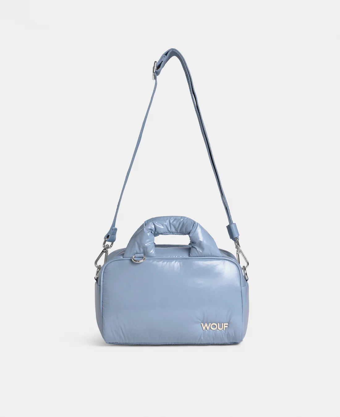 Blue handbag with a strap on a light gray background