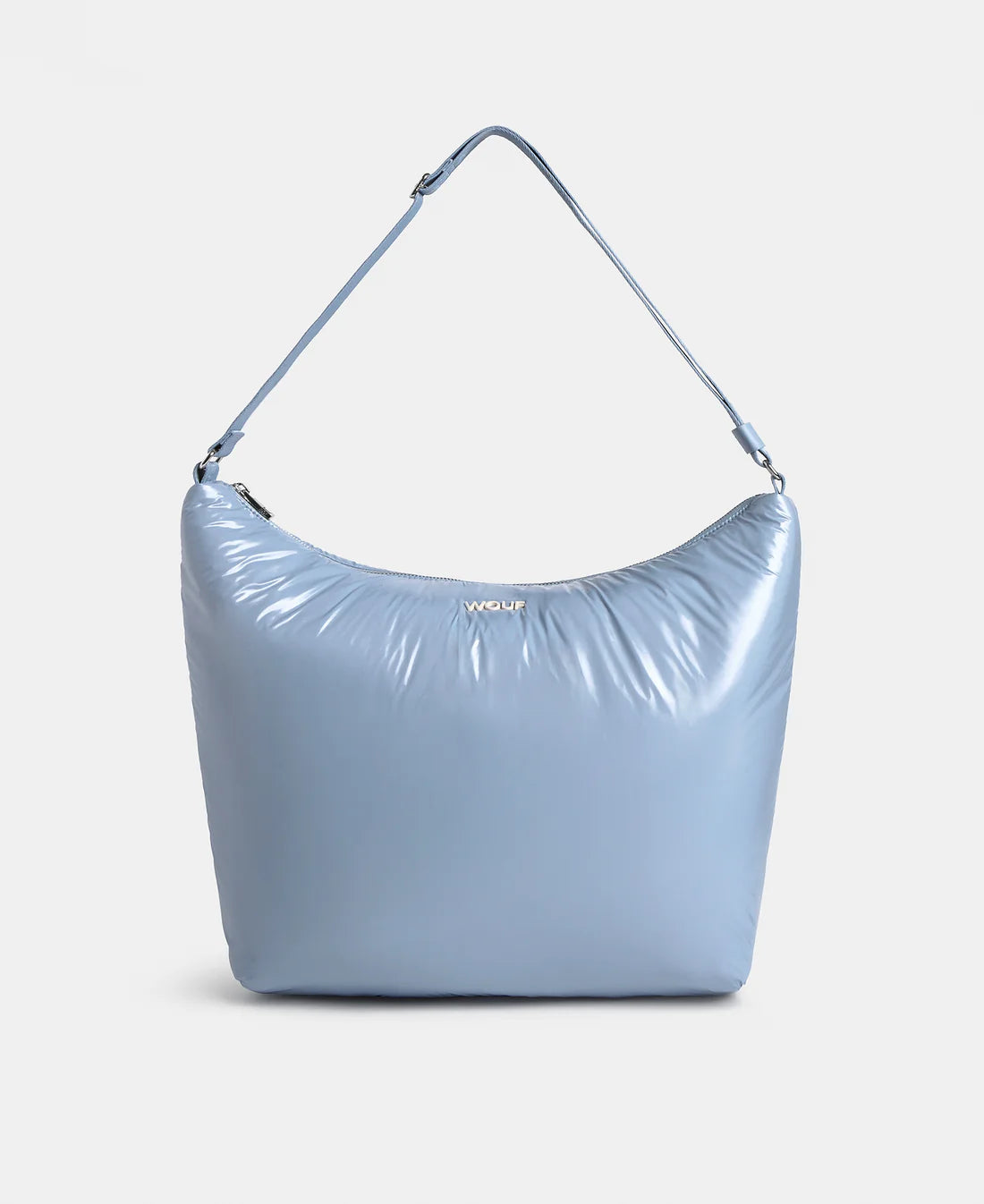Blue handbag with a strap on a light gray background