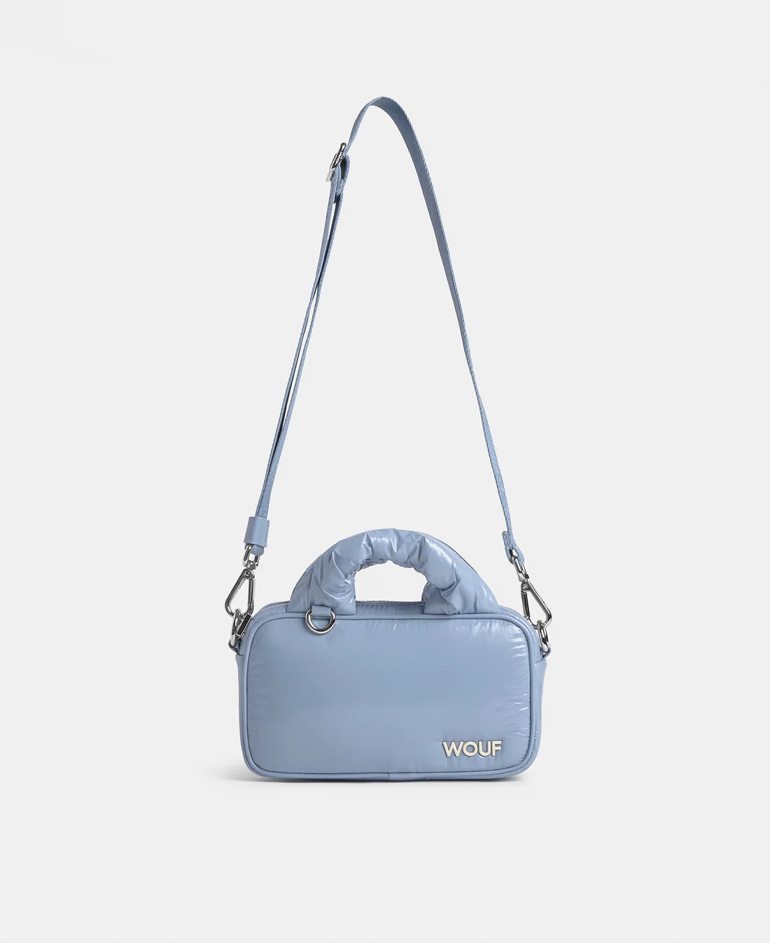 A light blue puffy top-handle handbag with a matching shoulder strap, silver-tone hardware, and the brand name 'WOUF' in silver on the front, shown against a light gray background.