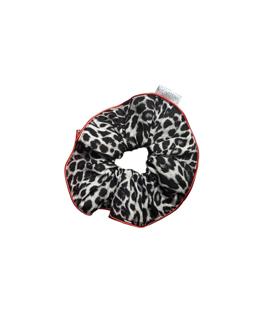 Leopard print scrunchie with red trim on a white background