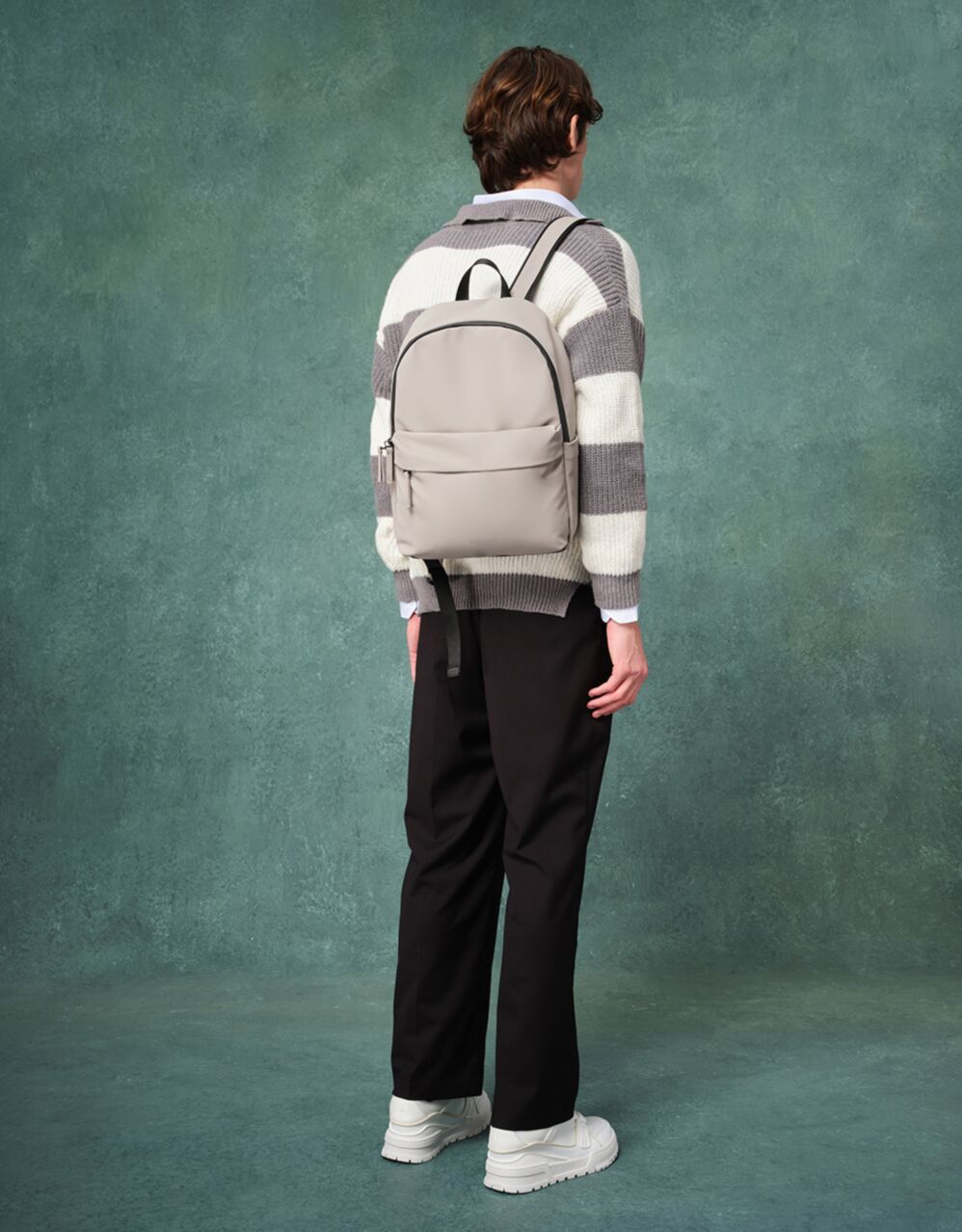 model showcasing the backpack on a green background 