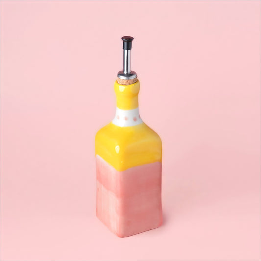Tierra Cocida Ceramic Oil Dispenser in Yellow & Pink /Valentina colours on a pink background 