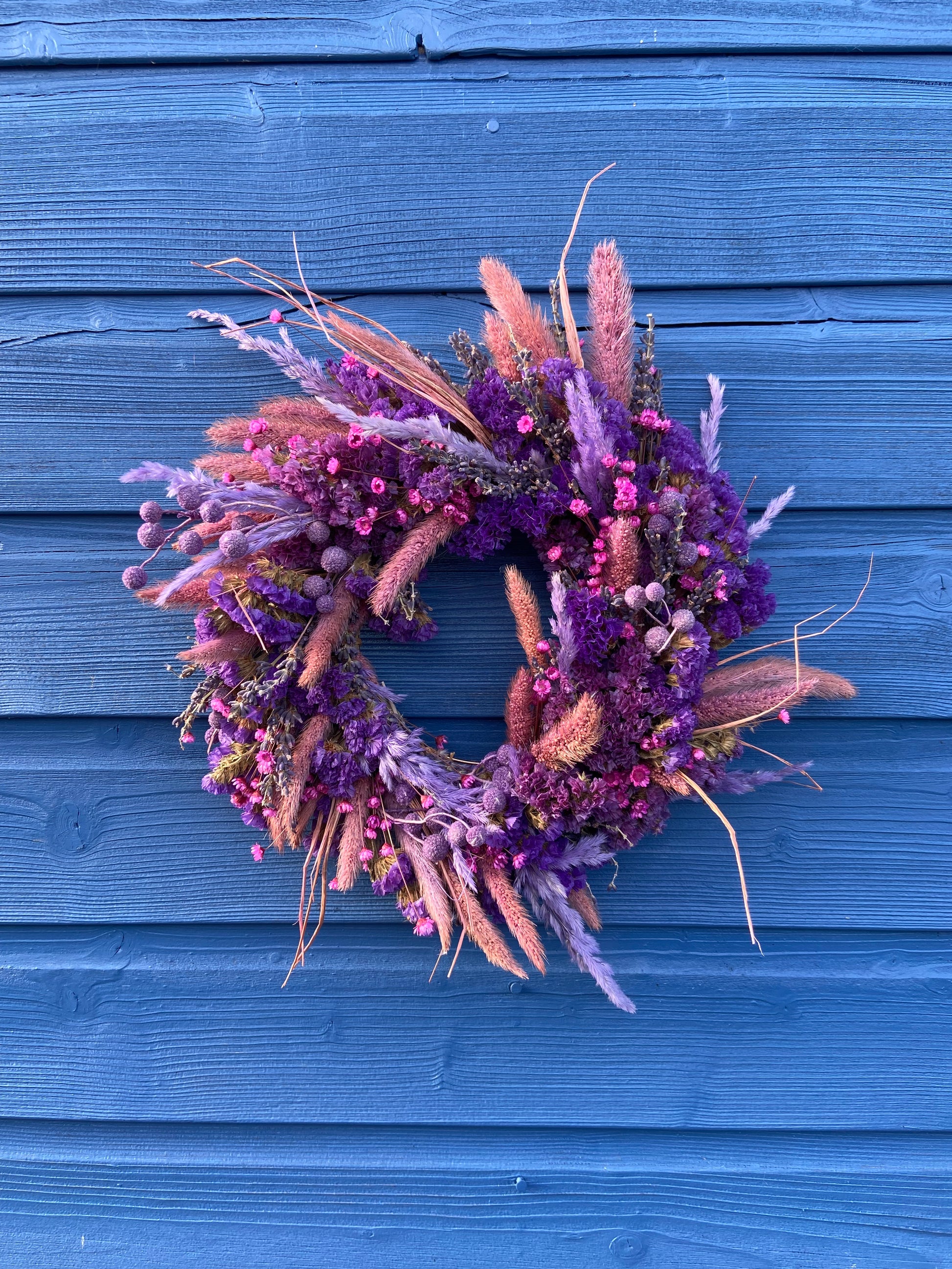 Modern Christmas Door Wreath made form beautiful purple and pink dry flowes. 