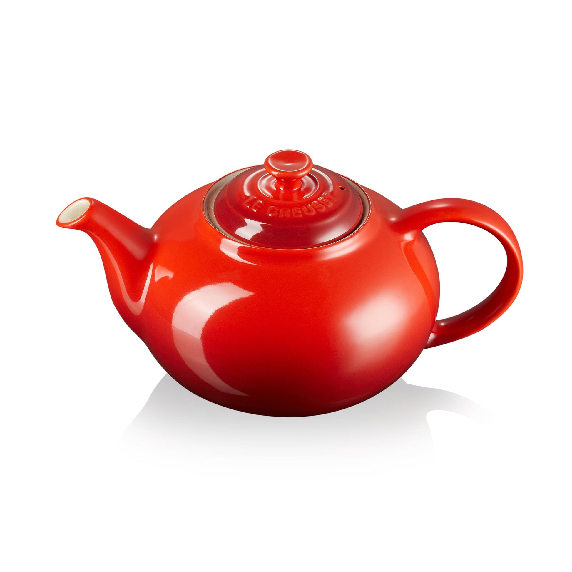 A classic red ombre tea pot with handle, lid and spout