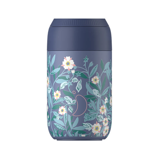 a blue coffee cup with a floral design