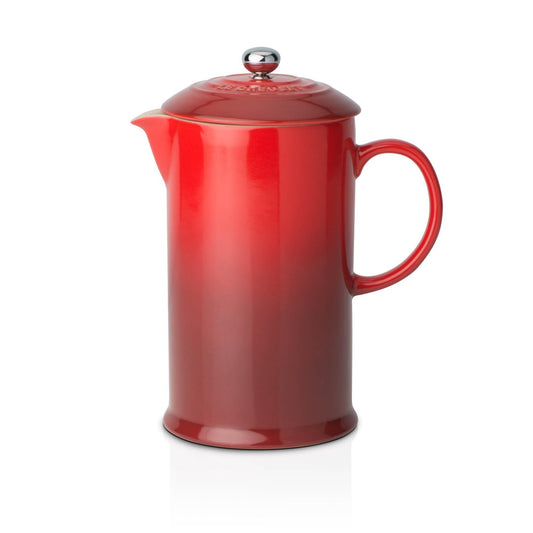 A red ombre cafetiere with a stone wear handle and a lid with a stainless steel handle
