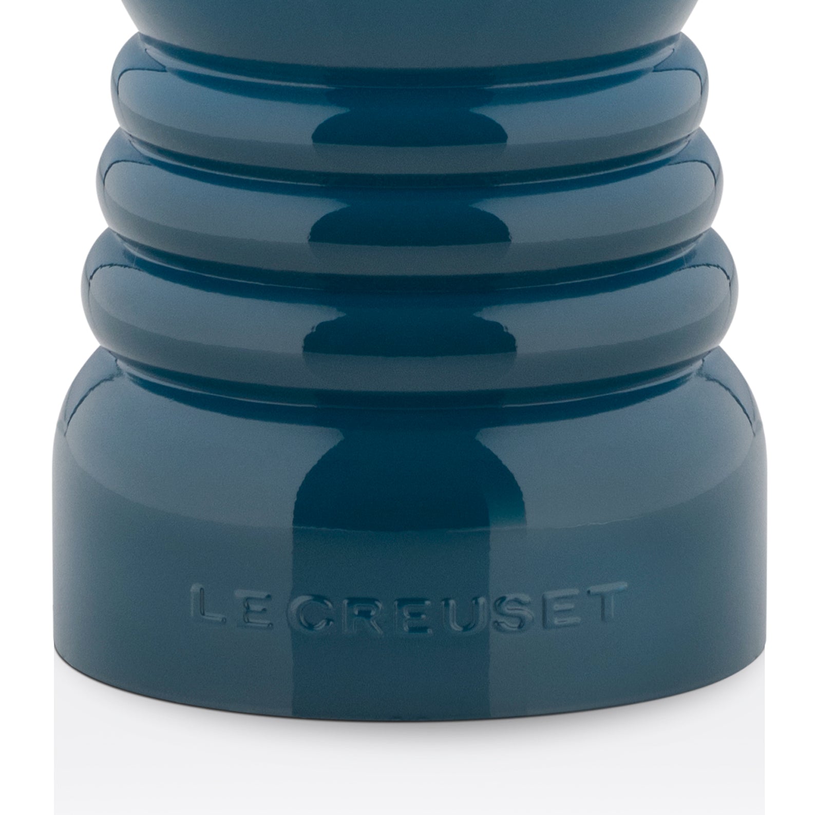 The bottom of the pepper mill with the embossed le creuset logo