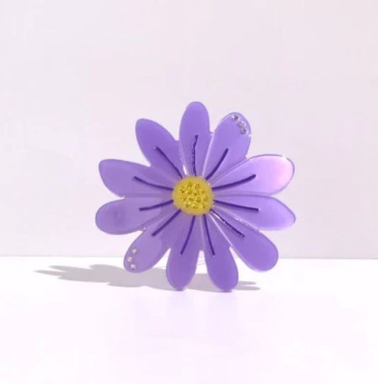 purple daisy hair clip on a white background 