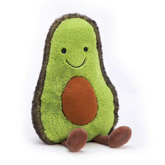 a LARGE GREEN AVOCADO SHAPED SHOFT TOY WITH A SMILEY FACE, LEGS AND A STONE IN IT'S BELLY