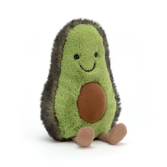 A smiling green avacado soft toy with a stone in in's belly and a pair of brown legs