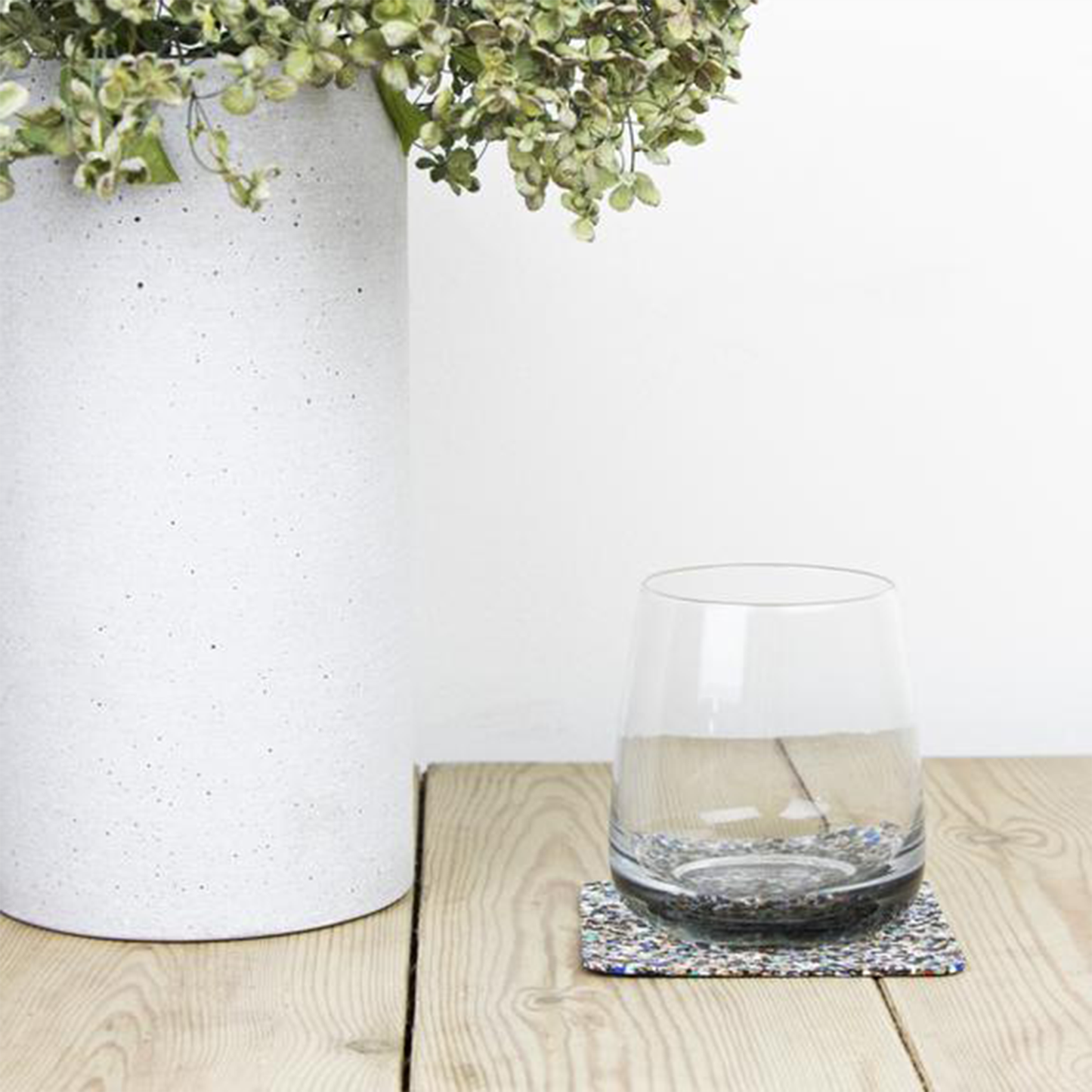 a glass sitting upon one of the coasters