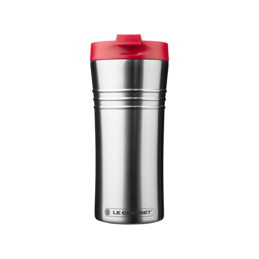 a stainless steel travel mug with the embossed le crueset logo and a red lid