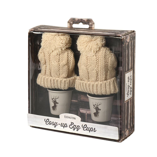 a wood print box with two egg cups with stags on and two wooly bobble hats