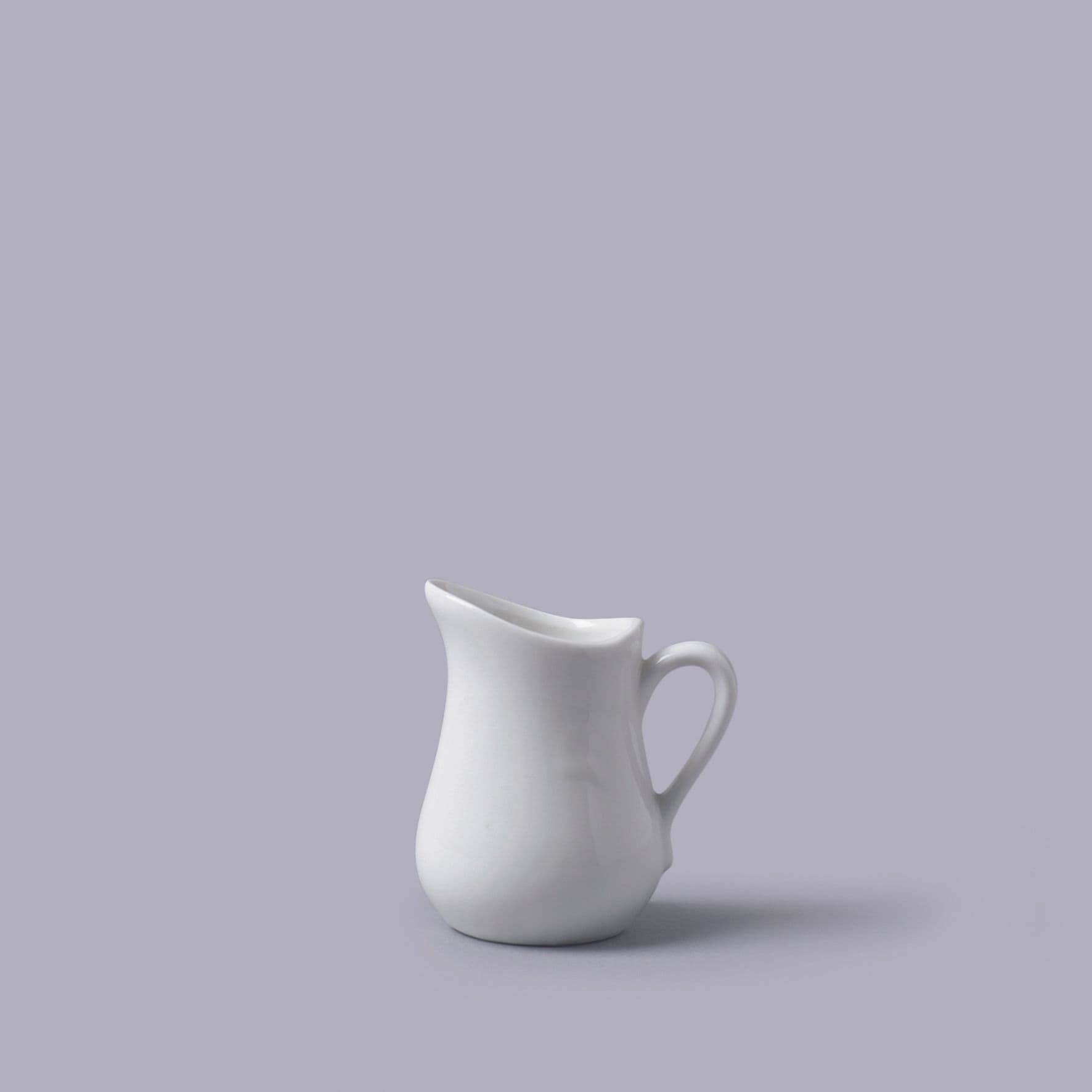 a small white cream jug with a handle 75ml