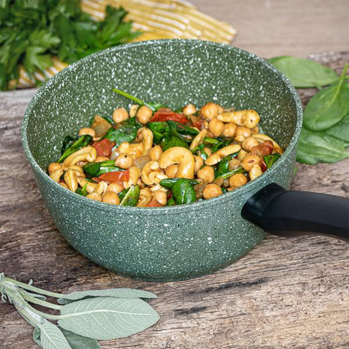 one of the pans with cashews, chickpeas and spinach in it