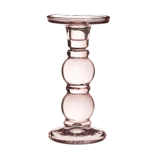 a tall pink candle holder with a wide base and top
