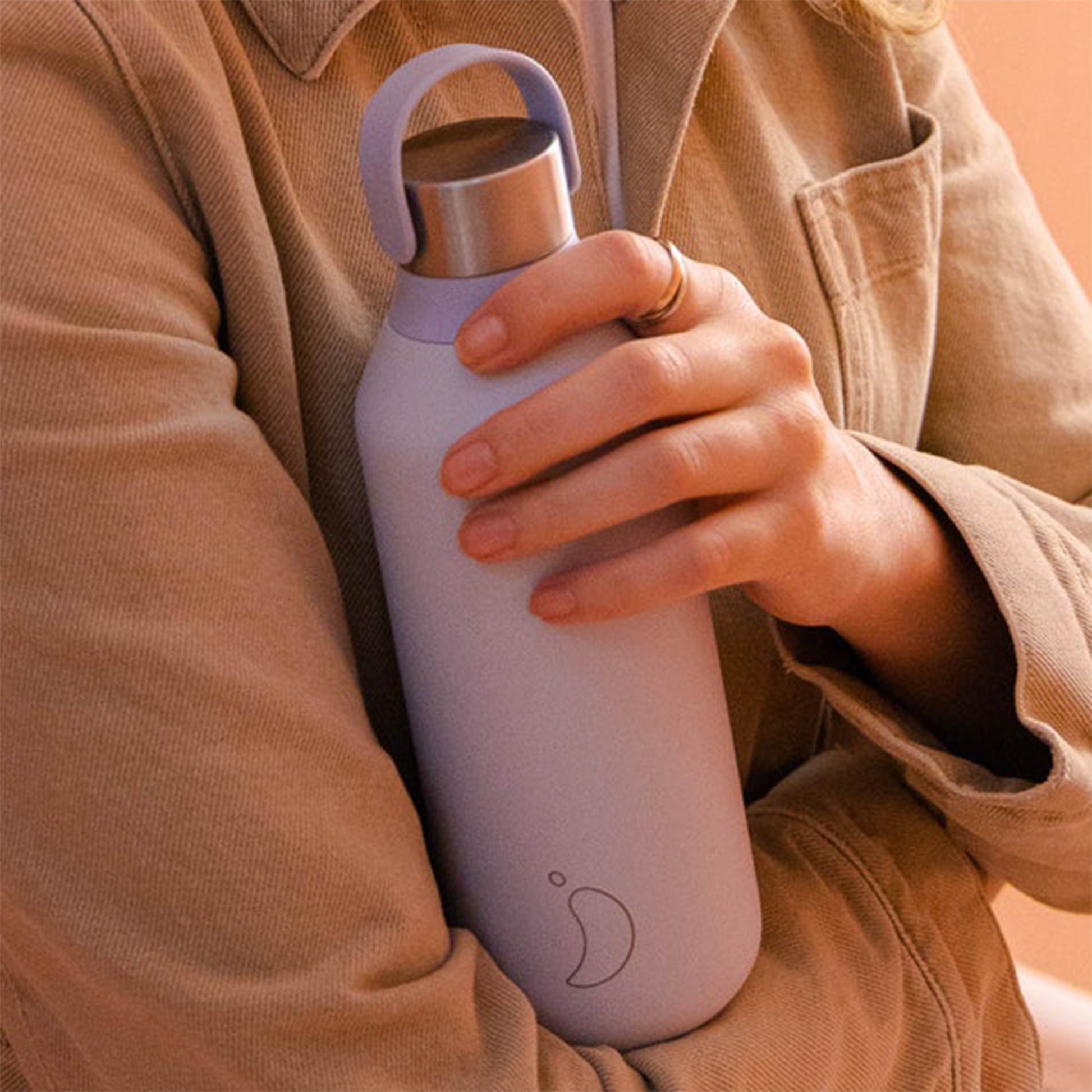 a woman in a shirt holding the bottle