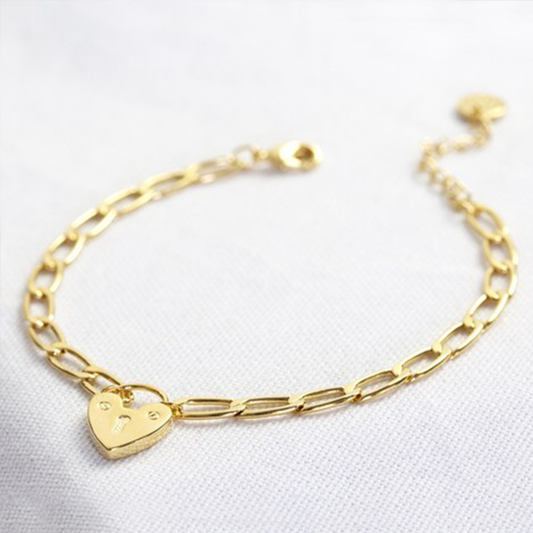 a gold chain bracelet with a heart lock charm