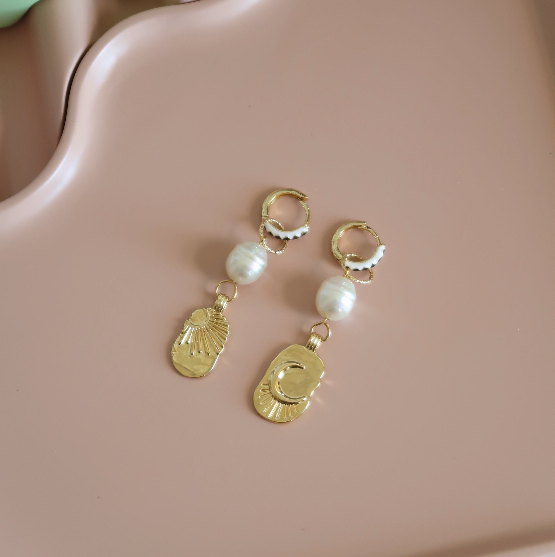 Gold hoop earrings with sun, moon and pearl charms 