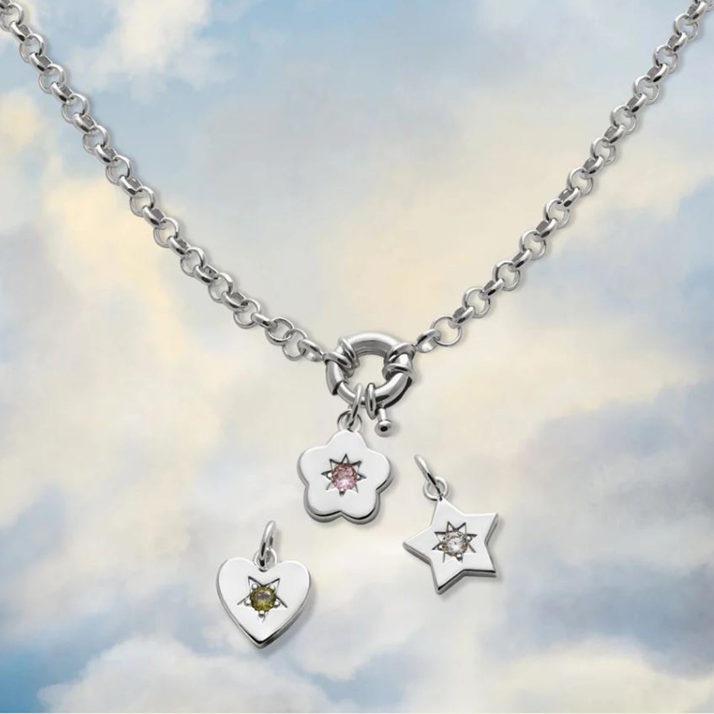 Silver Charm necklace with gemstones on a cloudy sky background