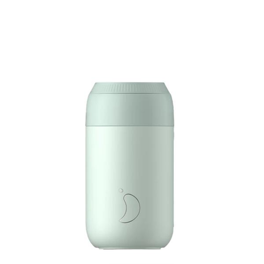 a pale pastel green travel mug