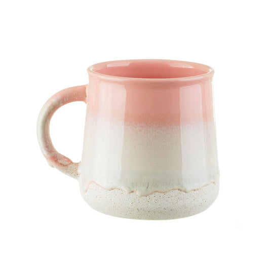 a stoneware mug with a pink and beinge natural ombre design
