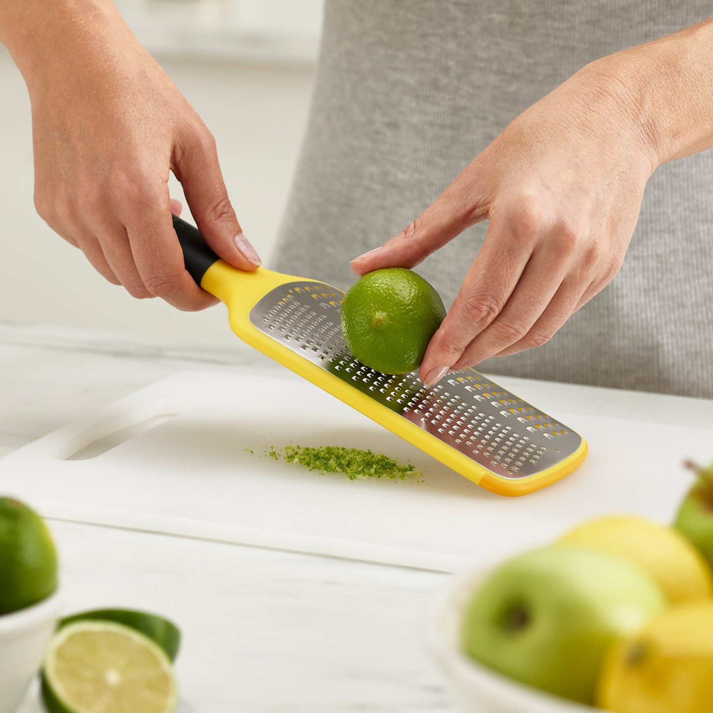 The multi-grate paddle grater zesting a lime