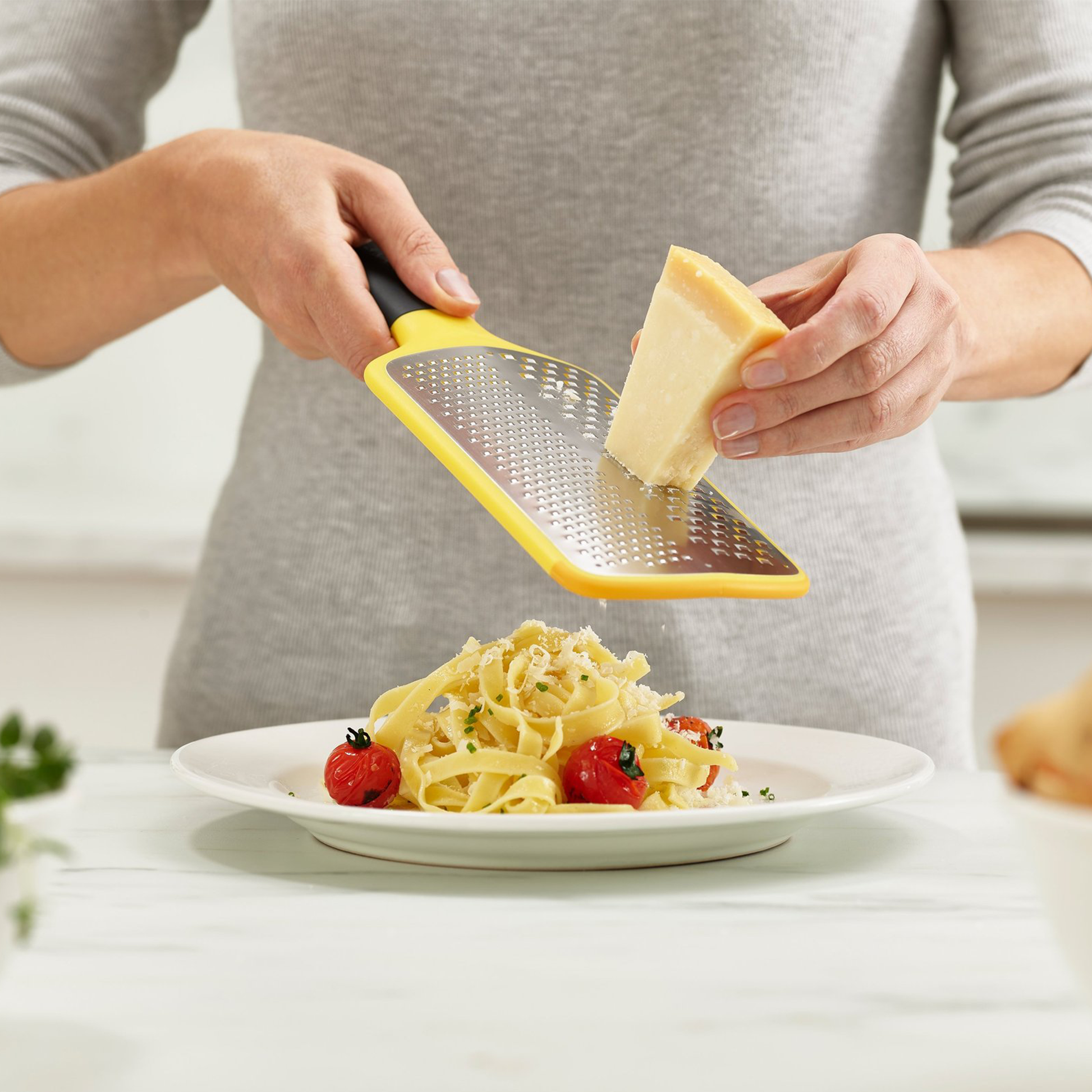 The multi-grate paddle grater grating parmesan cheese