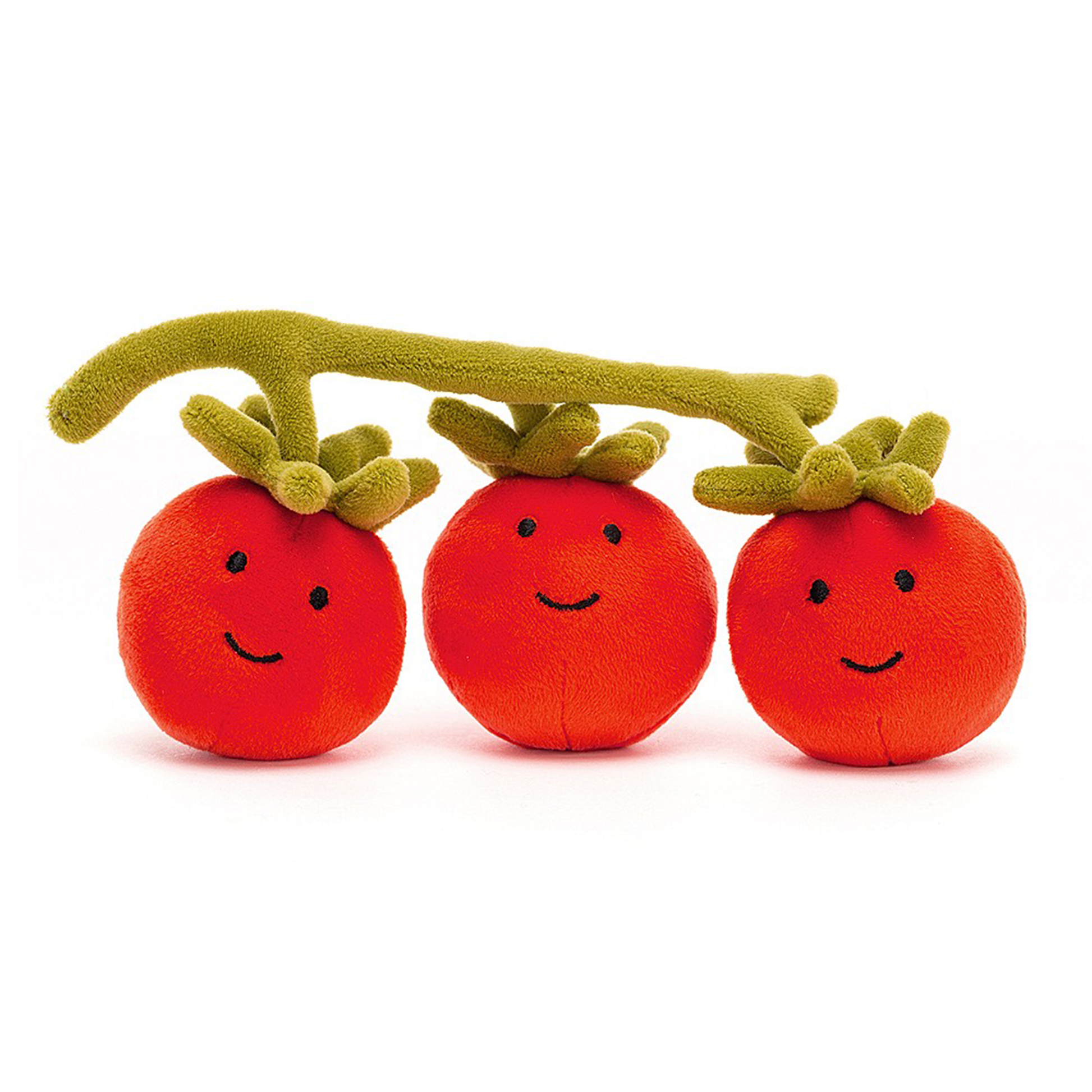Three smiling red tomatoes on a green vine