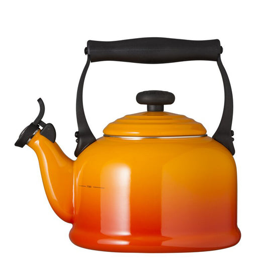 a stove top kettle with a red and orange ombre design and black handles and spout lid