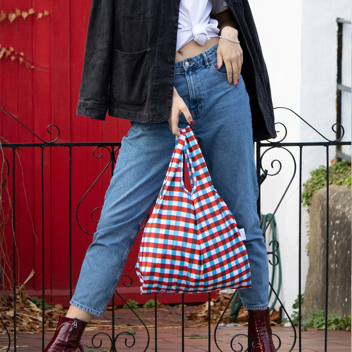 a women posing with the bag at her garden gate